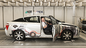 Professor Albert Albers in a fuel cell vehicle on a roller dynamometer. (Photo: Laila Tkotz, KIT)