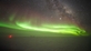 Aurora borealis over the South Pole. The IceCube laboratory can be seen as a red dot, the neutrino experiment itself is embedded kilometre deep in the ice. (Photo: Kathrin Mallot, IceCube, NSF)
