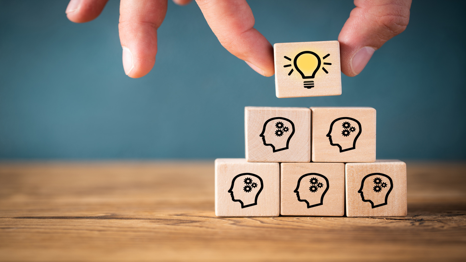 AdobeStock Blocks with brain and light bulb icons, symbolizing ideas and creativity.