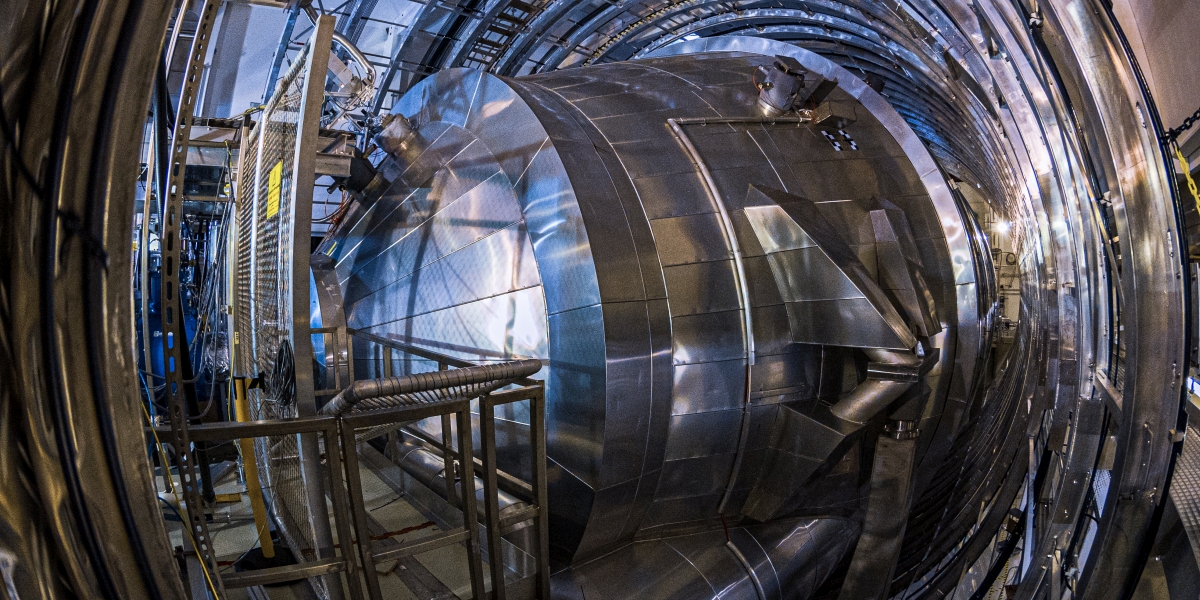 Exterior view of KATRIN, the neutrino experiment at KIT. The large steel tube displayed in the picture is the main part of the facility.