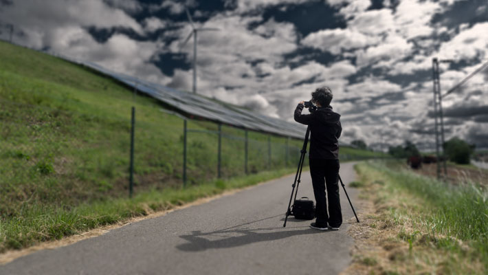 Frau mit Kamera in Landschaft