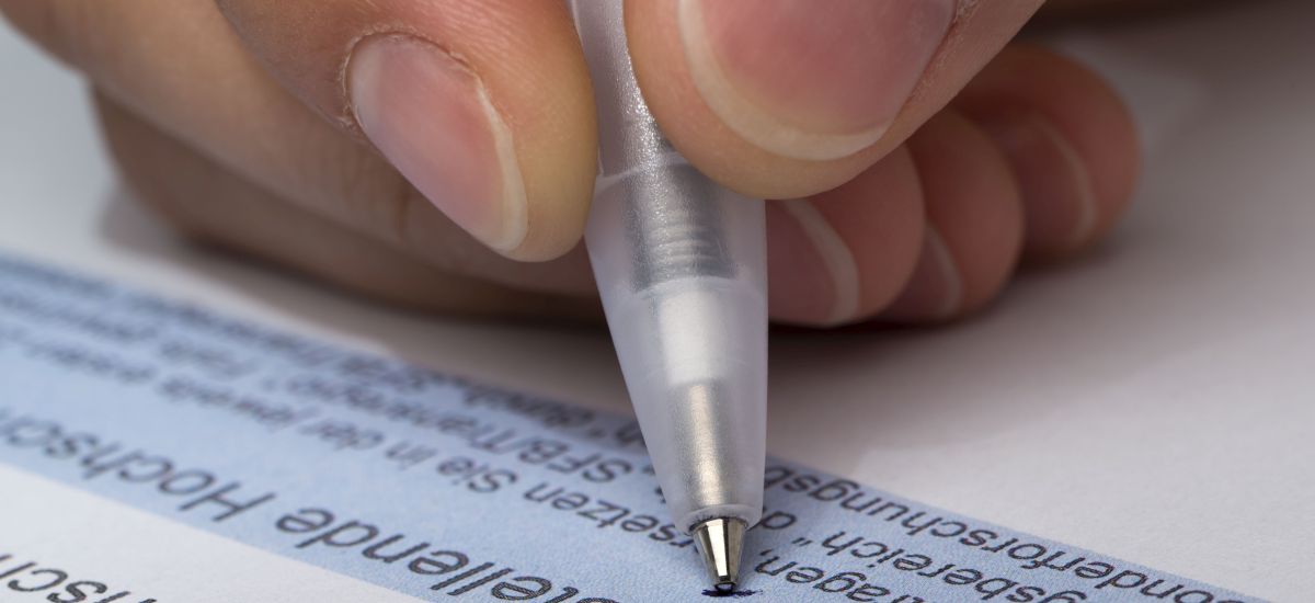 Hand signing a document