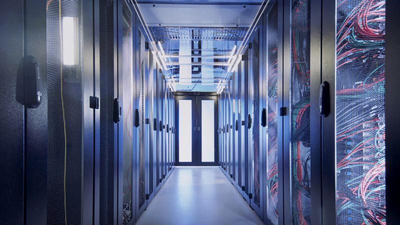 Amadeus Bramsiepe, KIT A modern data center with rows of server racks and colorful cabling.
