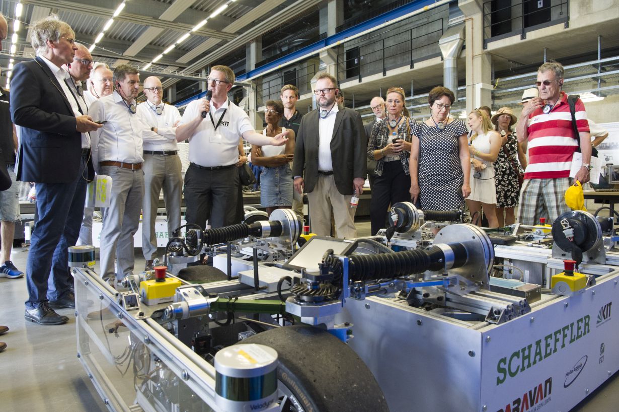 Hands-on science: demonstrator vehicles and more on Campus East; Professor Holger Hanselka on the left in the picture (photo: Markus Breig, KIT)